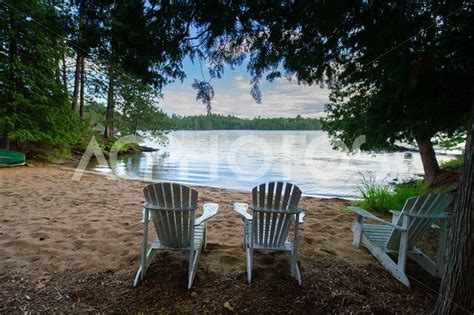 White Adirondack Chairs On A Beach Gettapix