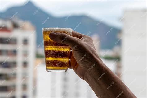 Premium Photo Man Holding Glass Of Beer On Blurred Urban City Background