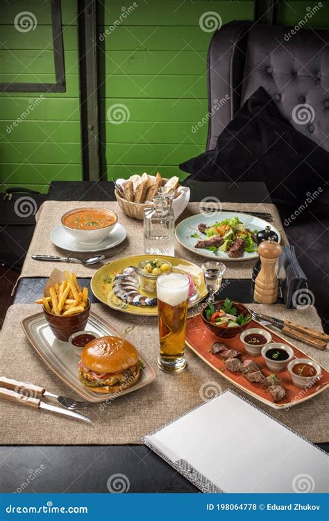 Gourmet Meals Assorted Set Steak Burger Fish Salad Beer On Wooden Table