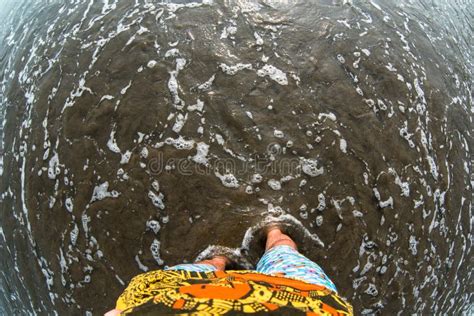 Man Feet On Water Sandy Beach Fisheye Effect Top View Stock Photo