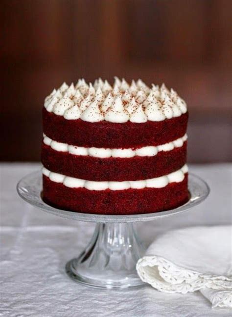 A Red Velvet Cake With White Frosting On A Plate