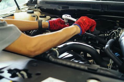 Premium Photo Cropped Hands Repairing Car In Garage