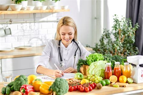 Female Nutritionist Young Doctor Writing Diet Plan On Table Right