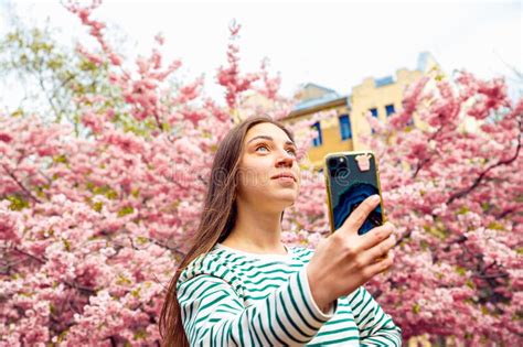 Young Female Posing For Smartphone Selfie Portrait Looking Up