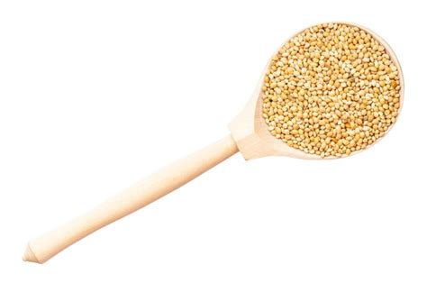 Premium Photo Unpolished Yellow Proso Millet In Wood Spoon