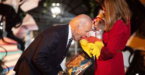 Biden Jokingly Bites Baby S Leg As He Greets Trick Or Treaters At White