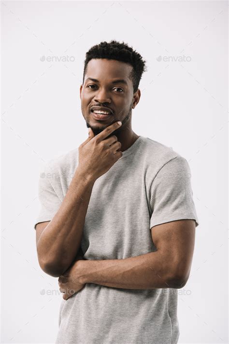 Happy African American Man Touching Face Isolated On White Stock Photo