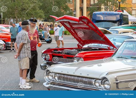 Two Men Discussing Classic Red Car With Hood Up Editorial Photo