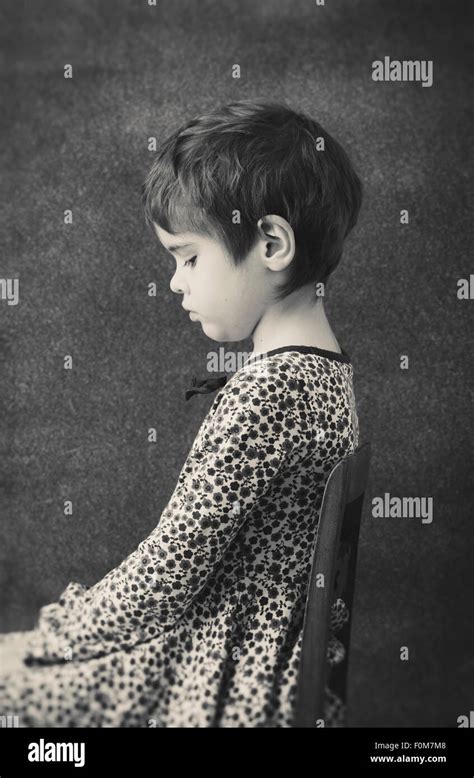 Side View Portrait Of Little Girl In Dress With Flowers She Is Stock