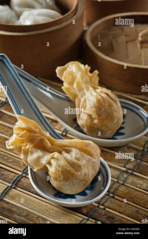 Won Ton In Chinese Spoons Steamed Dumplings In Steamer Basket Stock