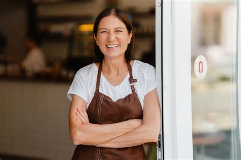 White Mature Barista Woman Smiling While Working In Cafe Stock Photo