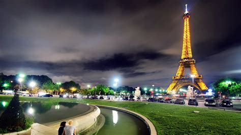 Yellow Lighting Paris Eiffel Tower With Shallow Background Of Dark Sky And Clouds During ...