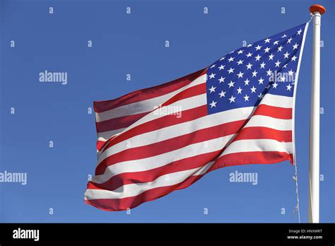 US flag flying in the wind Stock Photo - Alamy