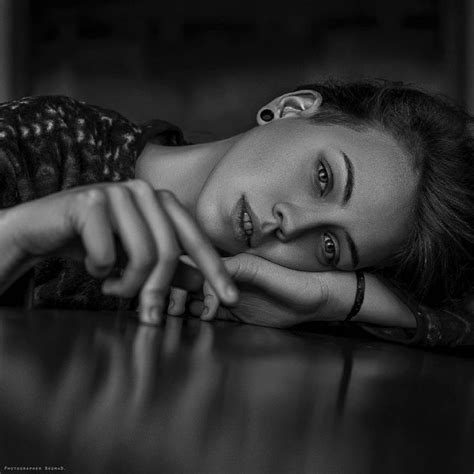 Black And White Photograph Of A Woman Laying On The Floor With Her