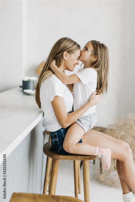 Mom Cares For Daughter Hugs And Kisses Stock Photo Adobe Stock