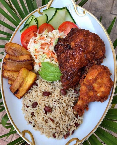 A White Plate Topped With Rice Meat And Veggies On Top Of A Table