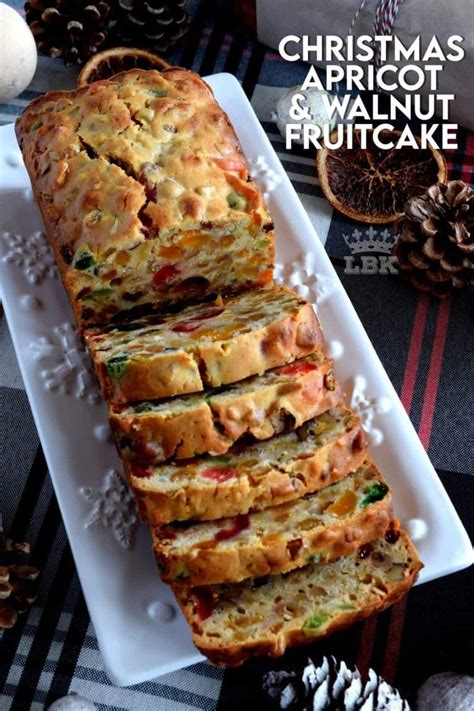 A White Plate Topped With Slices Of Fruitcake Next To Pine Cones And