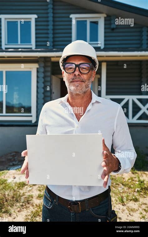 Confident Engineer Holding Blank Piece Of Paper Stock Photo Alamy