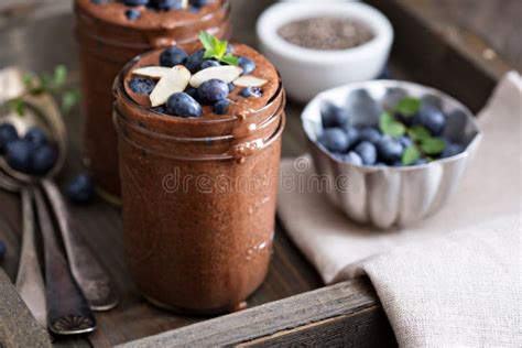 Chocolate Chia Pudding In Portion Glasses On A White Marble Table