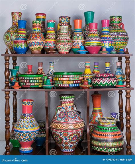 Colorful Painted Pottery Vases Stacked In Wooden Storage Shelves Stock