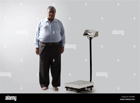 Portrait Of Obese Man With Weighing Scale Stock Photo Alamy