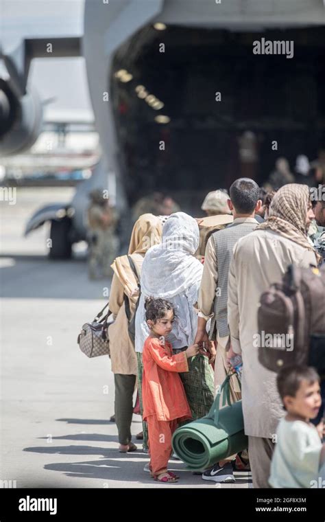 Afghan Families Wait To Board A U S Air Force C 17 Globemaster Iii Aircraft During Evacuation