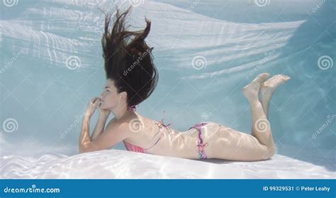 Woman Wearing A Bikini Swimsuit Holding Her Breathe Underwater Stock