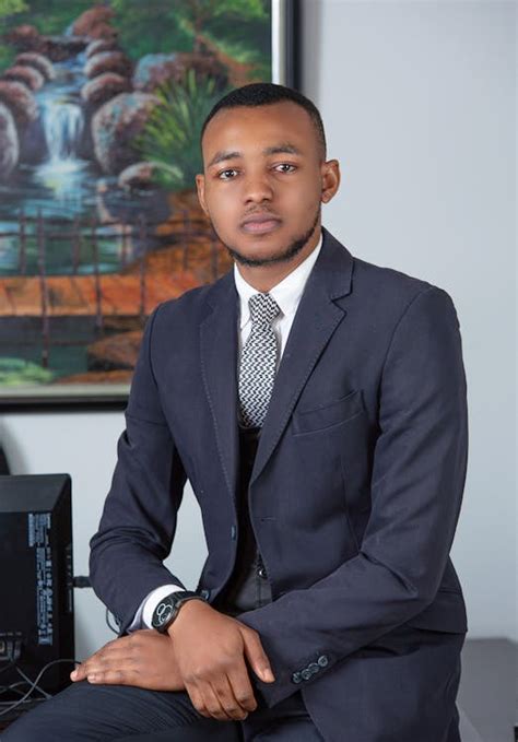 Man In Suit Sitting On Desk · Free Stock Photo