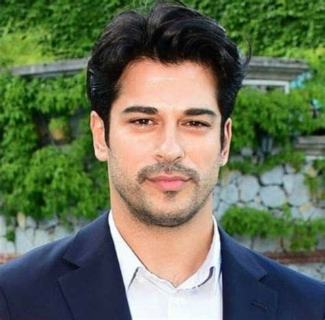 A Close Up Of A Person Wearing A Suit And Tie With Trees In The Background