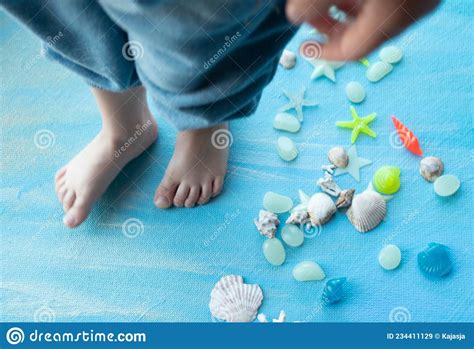 Baby Feet on Seashells Summer Background. Many Different Seashells ...