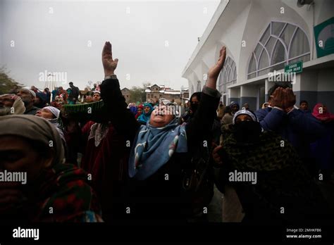 A Kashmiri Muslim Woman Cries And Raises Her Hands In Air To Pray As