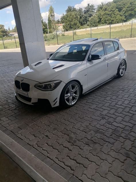 BMW 1 Series - White Car Parked in Front of Building