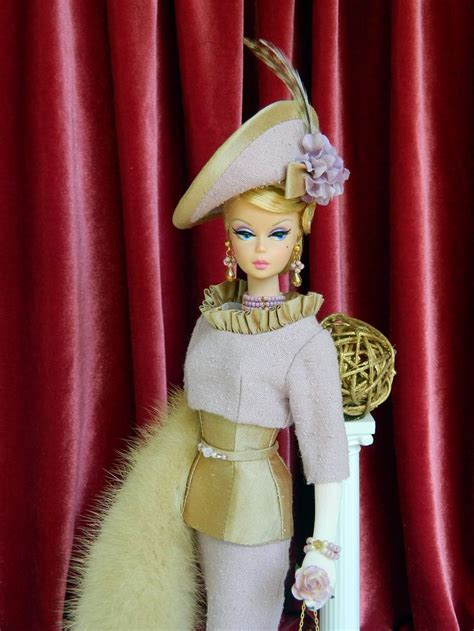 A Barbie Doll Wearing A Dress And Hat With Feathers On It S Head