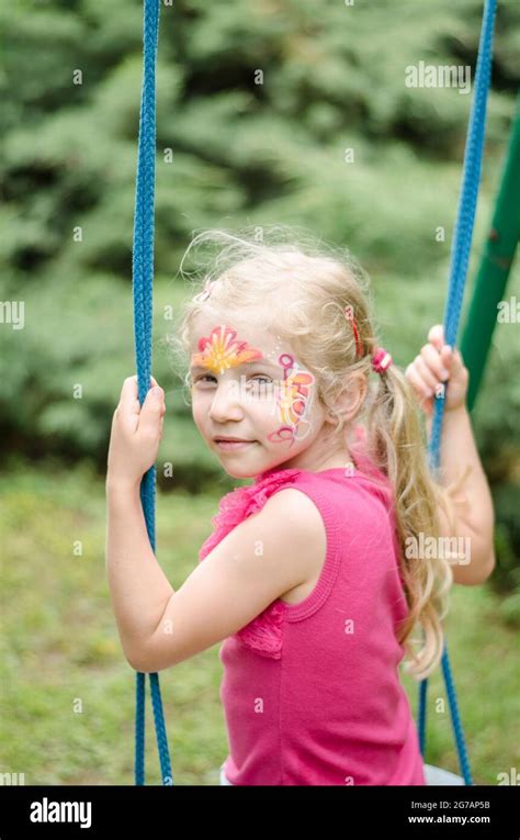 niño pequeño divirtiéndose balanceándose en el parque Fotografía de