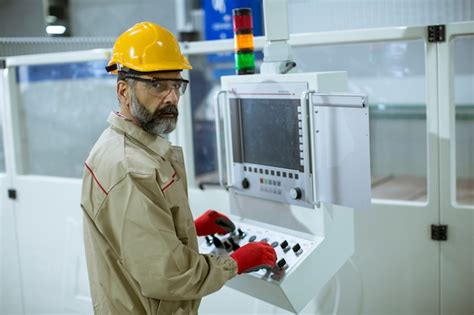 Premium Photo Senior Man Operating Machine Units In Modern Factory