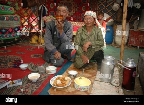 Nomads man woman offer food and drinks in their yurte Kharkhiraa Mongolian Altai near Ulaangom ...