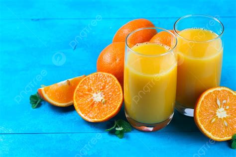 Orange Juice Two Glasses With Oranges On Blue Wooden Table Background