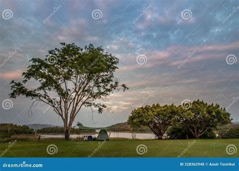 View Of A Camping Tent With Awning Pitched On The Grass Under Beautiful