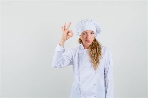 Free Photo Female Chef Showing Ok Sign And Winking Eye In White Uniform