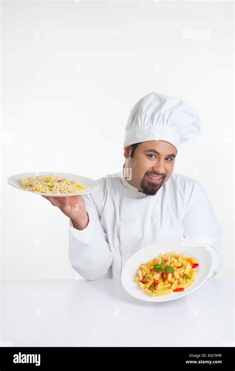 Portrait Of Chef Holding Plates With Pasta Stock Photo Alamy