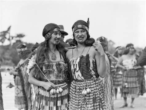 two women dressed in native american clothing posing for the camera