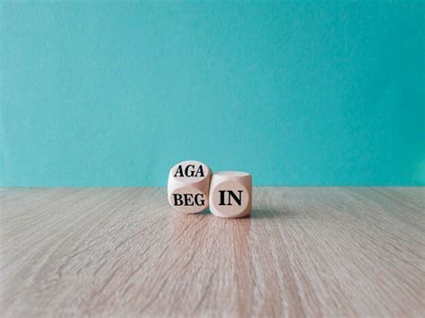Premium Photo | Begin again symbol turned wooden cube and changes the ...