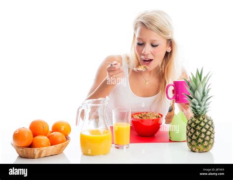 Blonde Woman Spooning Cornflakes Stock Photo Alamy