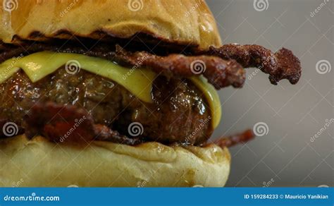 Juicy Cheeseburger With Crispy Bacon In Grilled Brioche Buns Close Up