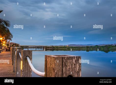 Overcast Sunrise Over Mossel Bay Lagoon From A Boardwalk With Bridge In