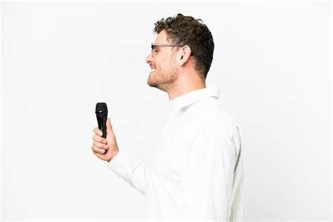 Premium Photo Brazilian Man Picking Up A Microphone Over Isolated