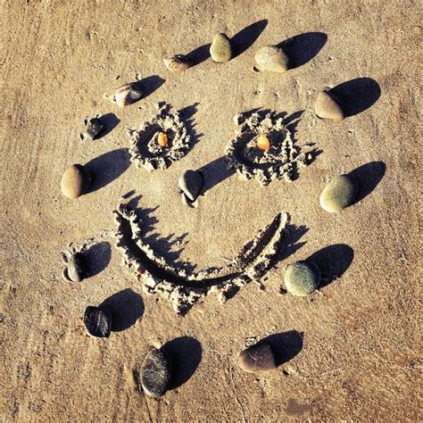 Premium Photo High Angle View Of Smiley Face Drawn On Sand At Beach