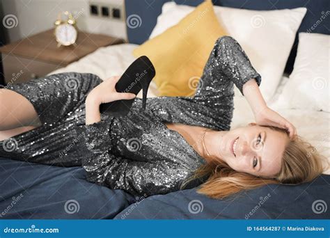 Young Woman In Elegant Black Evening Dress Lying In Bed Adult