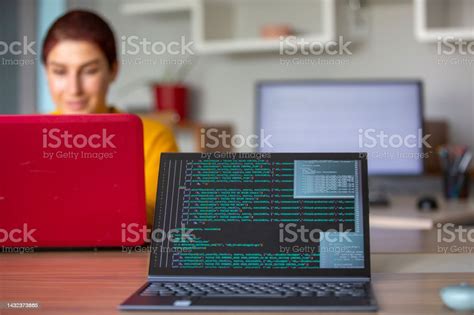 Female Programmer Coding On A Desktop Computer And Laptop Stock Photo