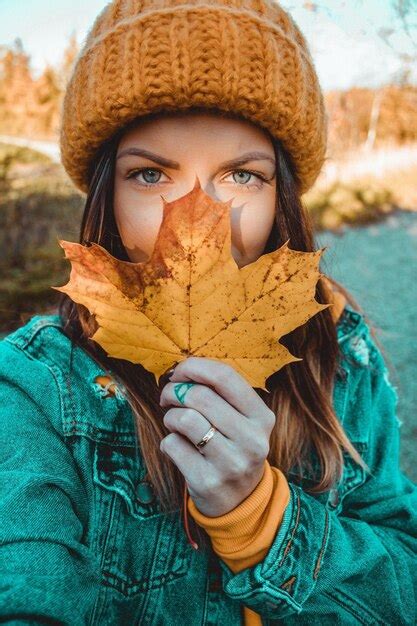 Premium Photo Portrait Of Woman Holding Maple Leaf